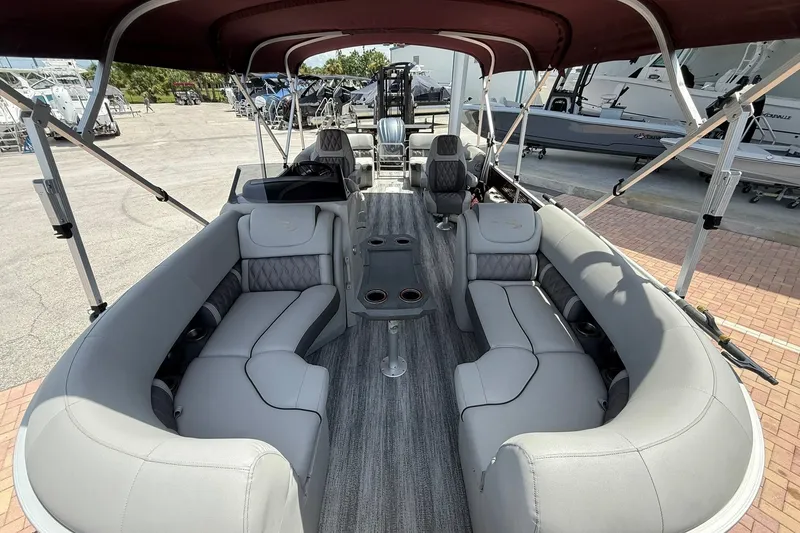 Slide: The Image of 2023 Bennington 23 LXFB pontoon boat interior with luxurious seating and canopy. - 25