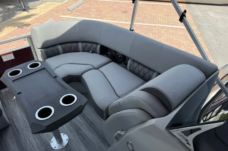 Slide: The Image of Luxurious seating area on 2023 Bennington 23 LXFB pontoon boat with cup holders and table. - 24