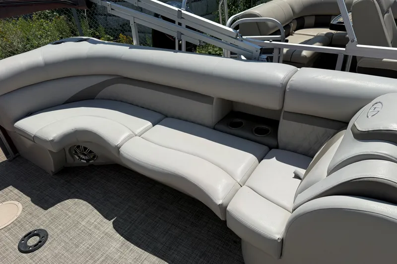 Slide: The Image of 2018 Harris Sunliner 220 boat interior with plush seating and cup holders. - 9