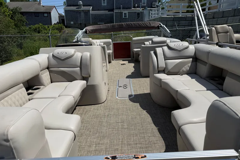 Slide: The Image of 2018 Harris Sunliner 220 pontoon boat with spacious beige seating and modern design. - 8