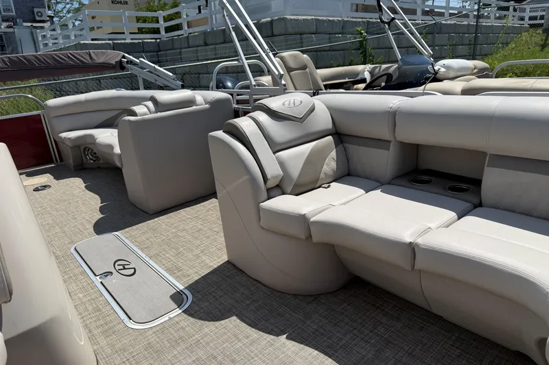 Slide: The Image of 2018 Harris Sunliner 220 pontoon boat interior with beige seating and carpeted flooring. - 14