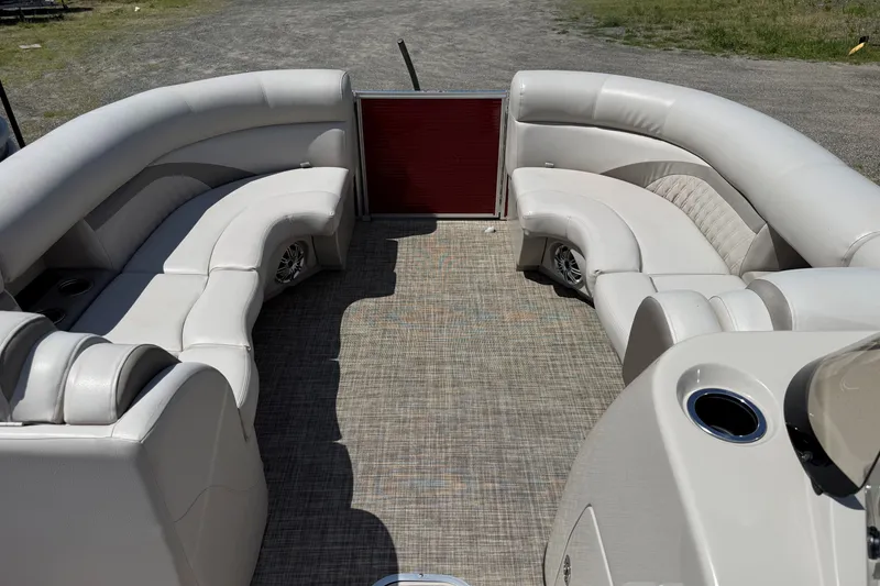 Slide: The Image of 2018 Harris Sunliner 220 pontoon boat interior with plush seating and cup holders. - 7