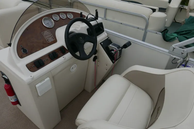 Slide: The Image of Steering console of a 2006 Crest 22 Super Sport boat with gauges and controls. - 9