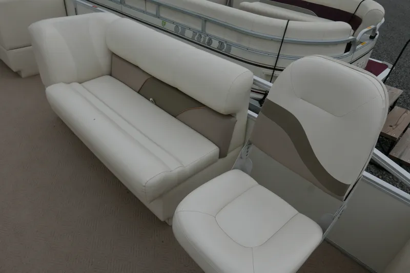 Slide: The Image of 2006 Crest 22 Super Sport boat interior with white seating and beige accents. - 6