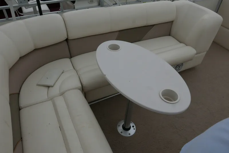Slide: The Image of Interior seating of 2006 Crest 22 Super Sport boat with oval table and cup holders. - 11