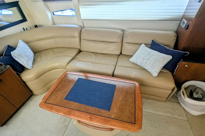 Slide: The Image of Luxurious interior of 2006 Meridian 341 Sedan with beige leather seating and wooden table. - 21