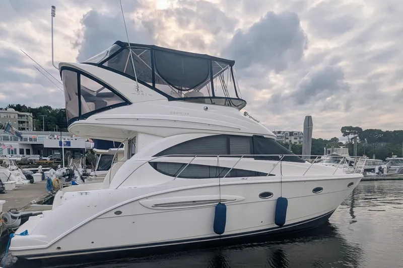 Slide: The Image of 2006 Meridian 341 Sedan yacht docked at marina under cloudy sky. - 2