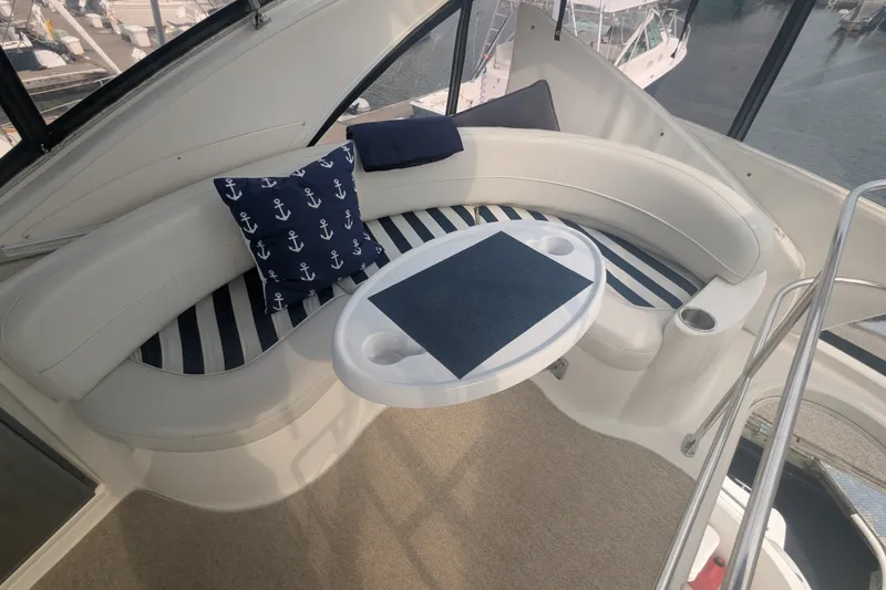 Slide: The Image of Luxurious seating area on a 2006 Meridian 341 Sedan yacht with nautical-themed cushions. - 14