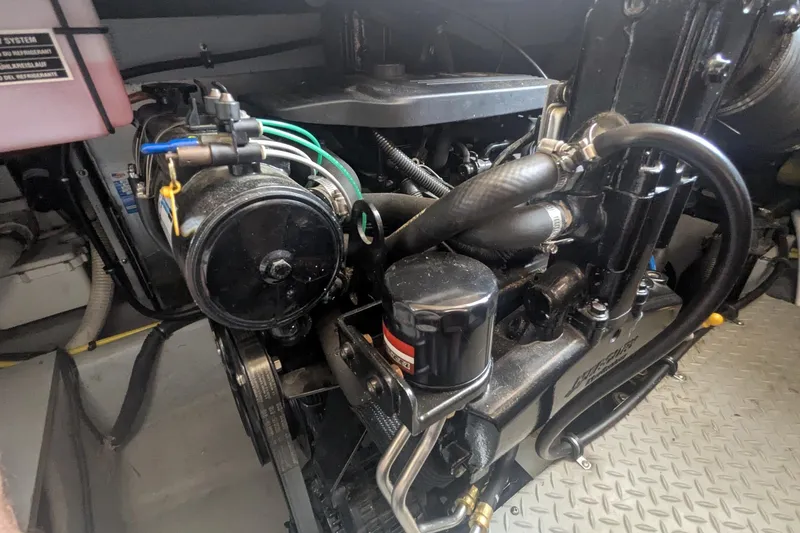 Slide: The Image of Engine compartment of a 2006 Meridian 341 Sedan, showcasing mechanical components and hoses. - 39