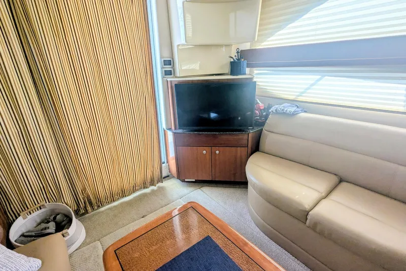 Slide: The Image of Interior of 2006 Meridian 341 Sedan yacht with TV, sofa, and wooden cabinetry. - 23