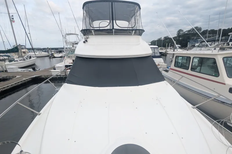 Slide: The Image of 2006 Meridian 341 Sedan yacht docked at a marina, surrounded by other boats. - 3