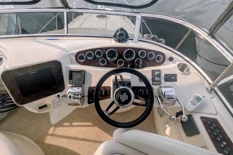 Slide: The Image of 2006 Meridian 341 Sedan helm with steering wheel, gauges, and navigation equipment. - 10