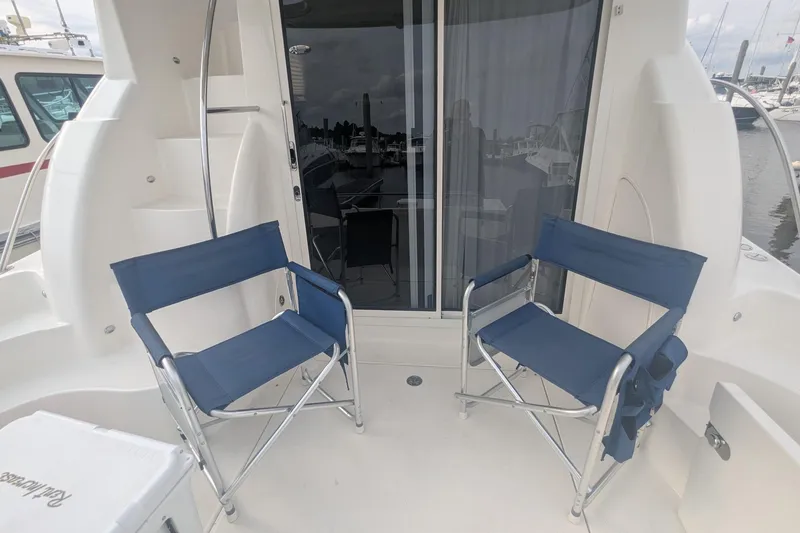 Slide: The Image of Two blue chairs on a 2006 Meridian 341 Sedan yacht deck. - 5