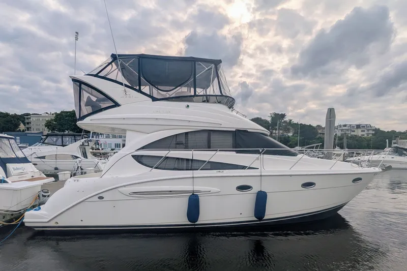 Slide: The Image of 2006 Meridian 341 Sedan yacht docked at marina under cloudy sky. - 1