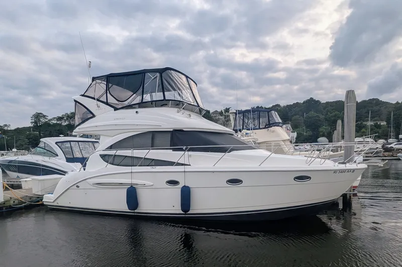 The Image of 2006 Meridian 341 Sedan yacht docked at marina under cloudy sky. - 0