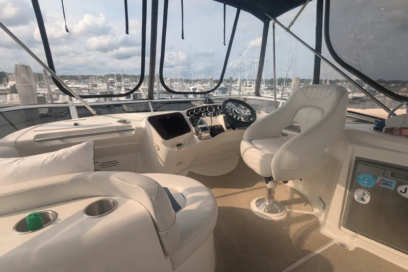 Slide: The Image of Interior view of 2006 Meridian 341 Sedan yacht cockpit with marina backdrop. - 11