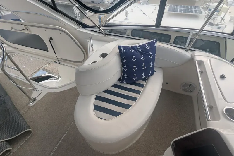 Slide: The Image of Interior of a 2006 Meridian 341 Sedan yacht with nautical-themed seating. - 13