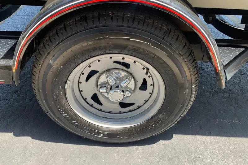 Slide: The Image of Trailer wheel of a 2005 Tracker Targa 17 WT boat, featuring chrome hubcap. - 12