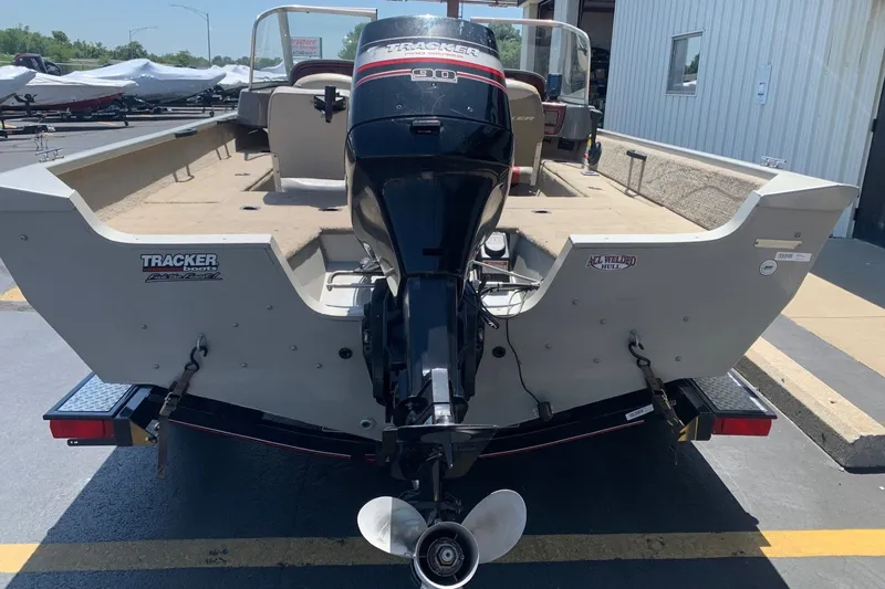 Slide: The Image of 2005 Tracker Targa 17 WT boat with outboard motor, parked on a trailer. - 4