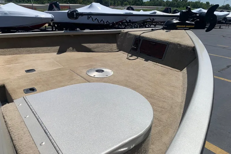 Slide: The Image of 2005 Tracker Targa 17 WT boat deck with Minn Kota trolling motor in a parking lot. - 8