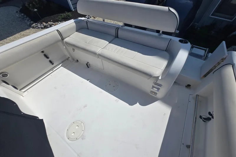 Slide: The Image of 2006 Robalo R265 Walkaround boat interior with white seating and spacious deck. - 4