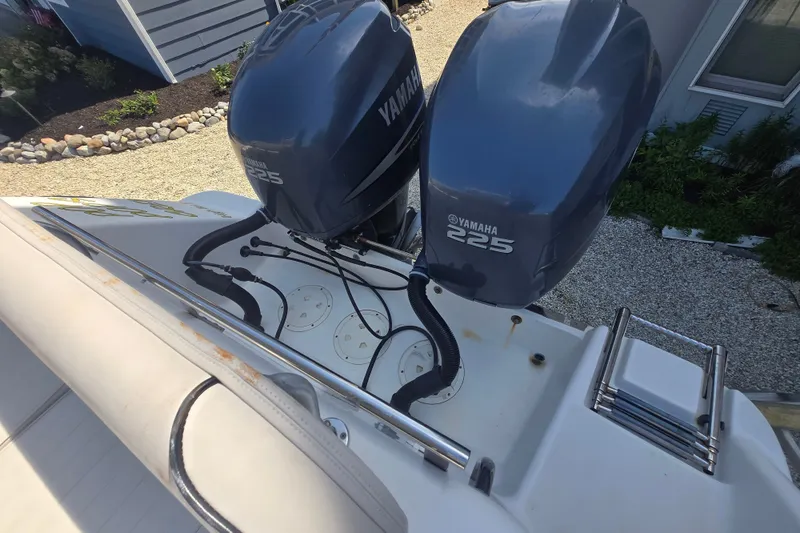 Slide: The Image of 2006 Robalo R265 Walkaround with dual Yamaha 225 engines, docked on gravel. - 28