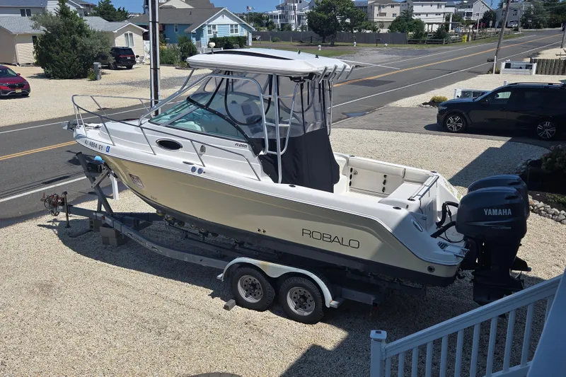 Slide: The Image of 2006 Robalo R265 Walkaround boat on trailer with Yamaha engine in residential area. - 8