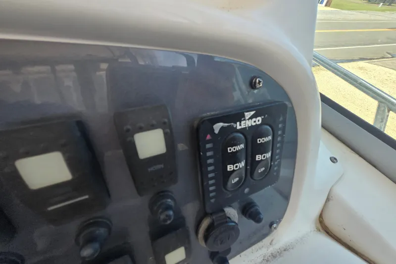 Slide: The Image of Control panel of a 2006 Robalo R265 Walkaround boat with Lenco trim tab switches. - 18