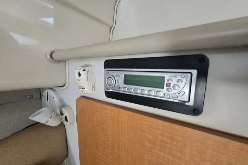 Slide: The Image of 2006 Robalo R265 Walkaround cabin interior with stereo system and control panel. - 20