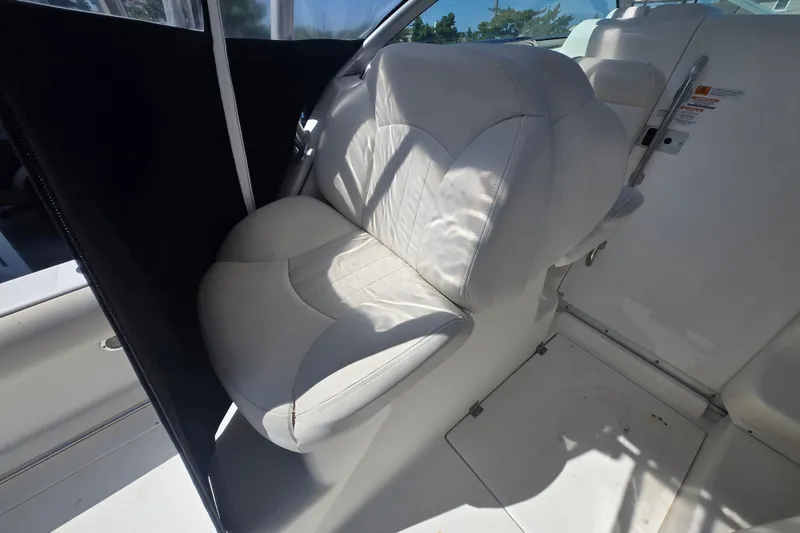 Slide: The Image of 2006 Robalo R265 Walkaround boat interior with white cushioned seating. - 11