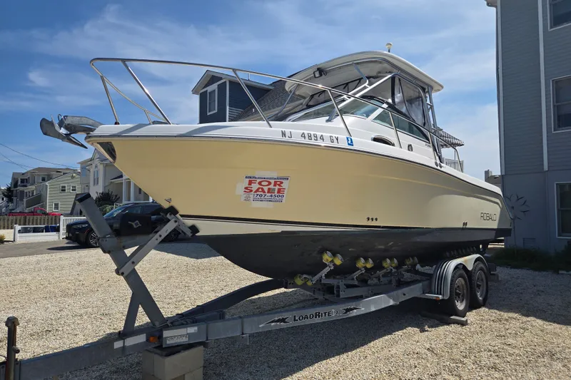 Slide: The Image of 2006 Robalo R265 Walkaround boat on trailer, for sale sign visible. - 32