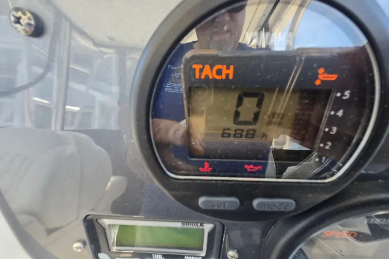 Slide: The Image of Close-up of a 2006 Robalo R265 Walkaround tachometer displaying 688 hours. - 12