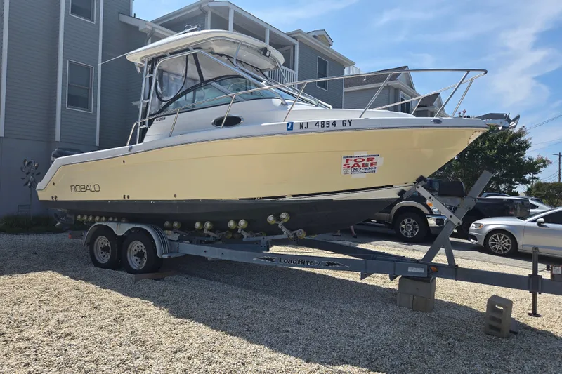 Slide: The Image of 2006 Robalo R265 Walkaround boat on trailer, for sale sign visible. - 31