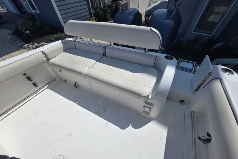 Slide: The Image of 2006 Robalo R265 Walkaround boat interior with cushioned seating and dual engines. - 27