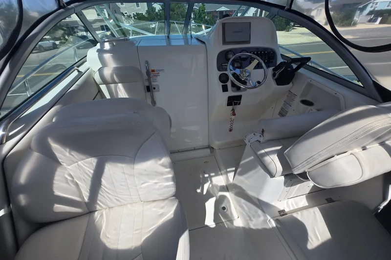 Slide: The Image of Interior of a 2006 Robalo R265 Walkaround boat with steering console and seating. - 2