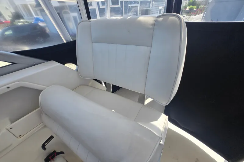 Slide: The Image of 2006 Robalo R265 Walkaround boat interior with white cushioned seating. - 25