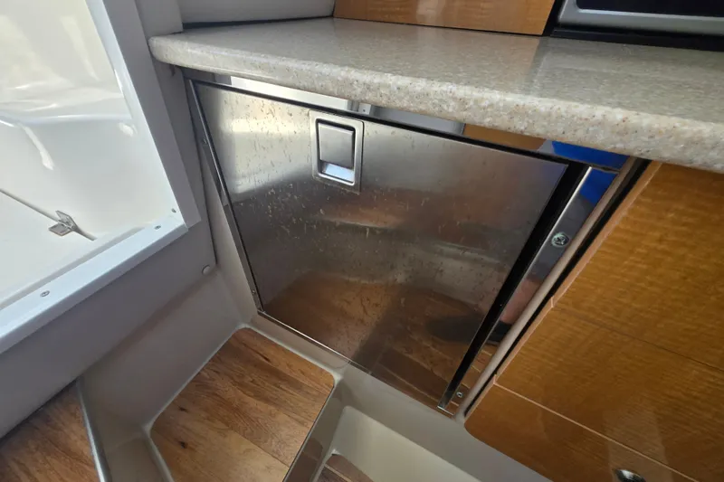 Slide: The Image of Interior of 2006 Robalo R265 Walkaround boat featuring a stainless steel cabinet. - 21