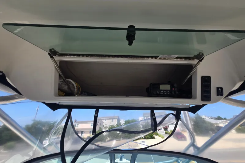 Slide: The Image of 2006 Robalo R265 Walkaround boat interior storage with radio equipment. - 24