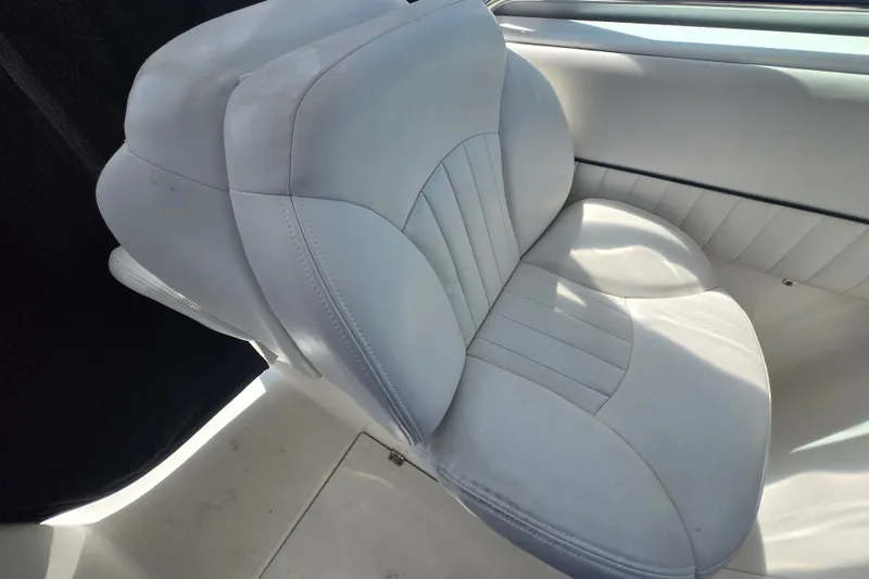 Slide: The Image of 2006 Robalo R265 Walkaround boat seat with white upholstery and sleek design. - 26