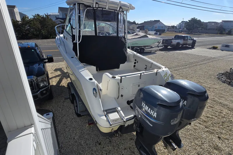 Slide: The Image of 2006 Robalo R265 Walkaround boat with twin Yamaha engines parked on a trailer. - 6