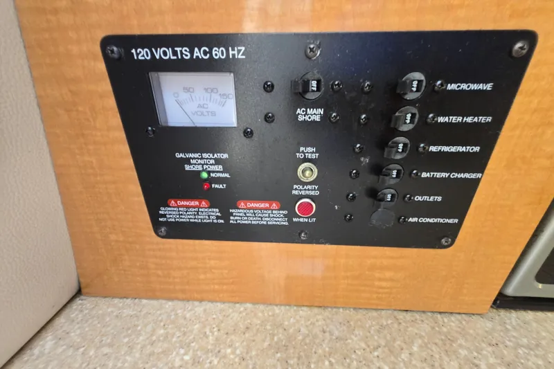 Slide: The Image of Electrical panel of 2006 Robalo R265 Walkaround boat, featuring 120 volts AC controls. - 23