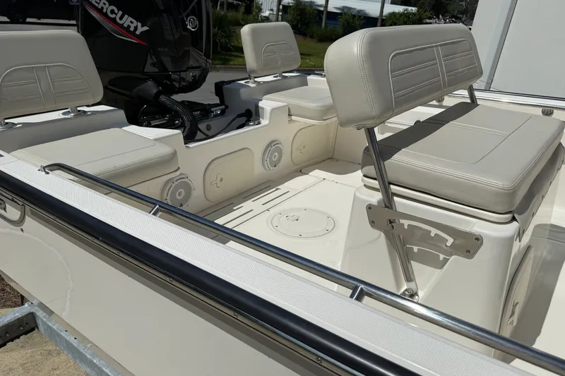 Slide: The Image of 2026 Boston Whaler 170 Montauk interior with cushioned seating and Mercury engine. - 8