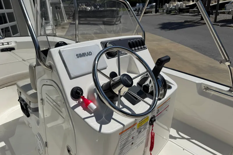 Slide: The Image of 2026 Boston Whaler 170 Montauk boat console with steering wheel and Simrad electronics. - 3