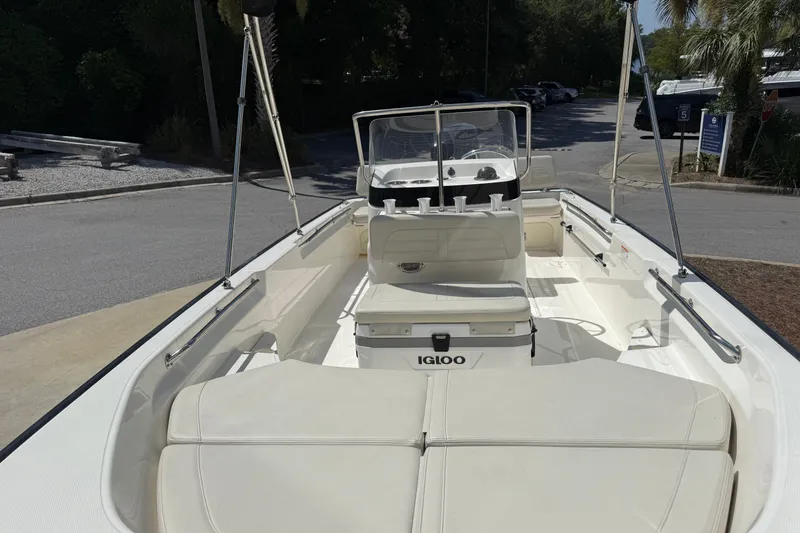 Slide: The Image of 2026 Boston Whaler 170 Montauk boat with Igloo cooler, parked on a sunny day. - 4