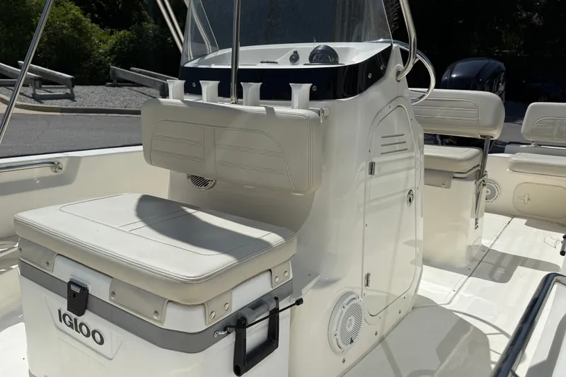 Slide: The Image of 2026 Boston Whaler 170 Montauk interior with seating and console, featuring Igloo cooler. - 6