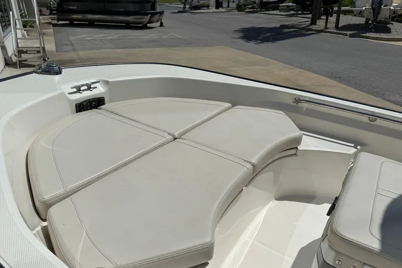Slide: The Image of 2026 Boston Whaler 170 Montauk boat interior with cushioned seating in sunlight. - 5