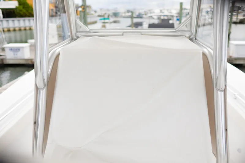 Slide: The Image of 2021 Onslow Bay 27 Offshore Edition boat console with protective cover in marina setting. - 28