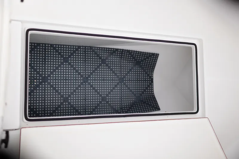 Slide: The Image of Storage compartment of 2021 Onslow Bay 27 Offshore Edition boat, featuring a non-slip mat. - 21