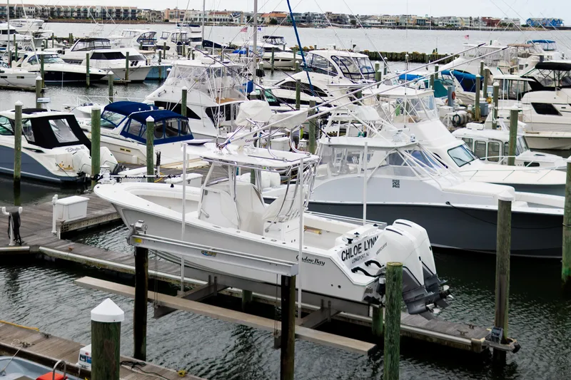 Slide: The Image of 2021 Onslow Bay 27 Offshore Edition boat docked in a busy marina. - 38