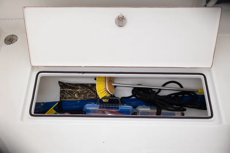 Slide: The Image of Storage compartment of 2021 Onslow Bay 27 Offshore Edition boat with cleaning tools and accessories. - 30